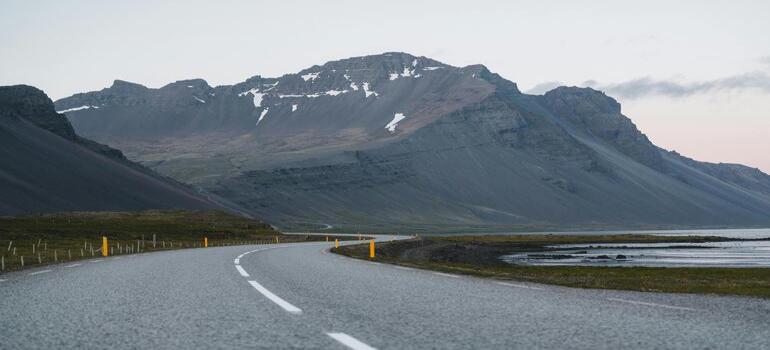 Open road under expansive cloudy sky.