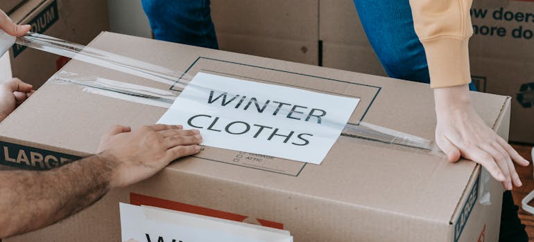A moving box labeled winter cloths