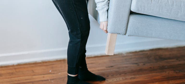 A person liftin sofa