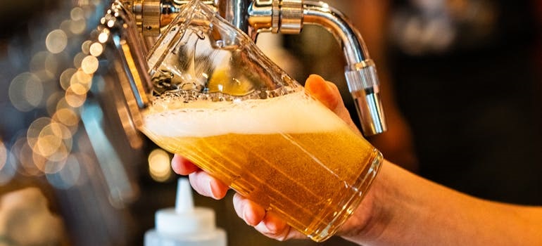 a bartender pouring bear at one of the must-visit festivals in Edmonton