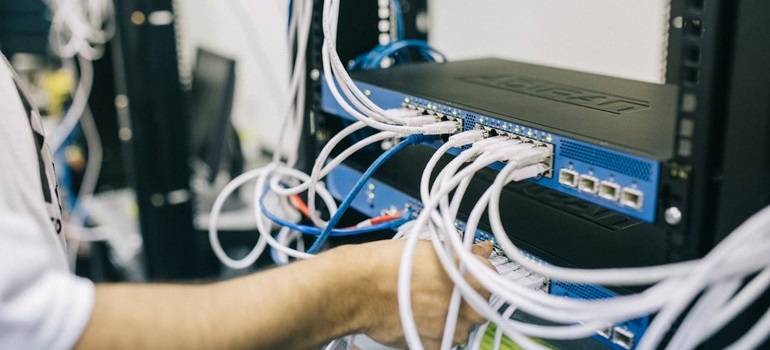 a man fixing internet cables