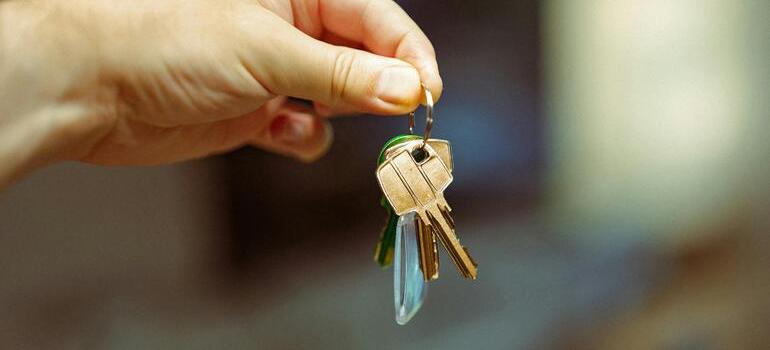 a person holding apartment keys