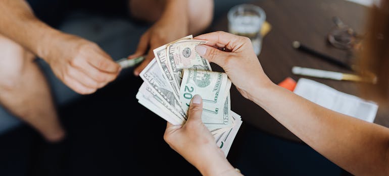 A person counting dollar bills