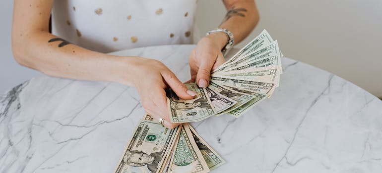Person holding dollar bills