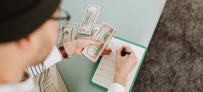 A person making moving budget and thinking about questions to ask your international movers