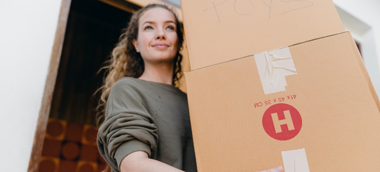 a woman carrying boxes