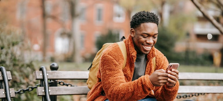A man using a phone to send a message