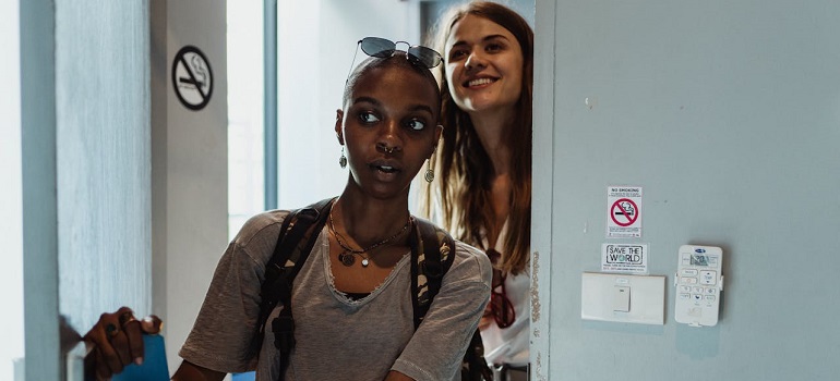 two girls entering a room