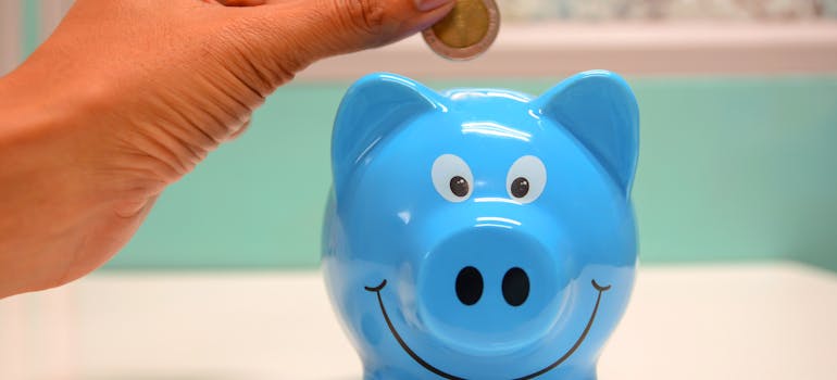 Putting coin in the piggy bank