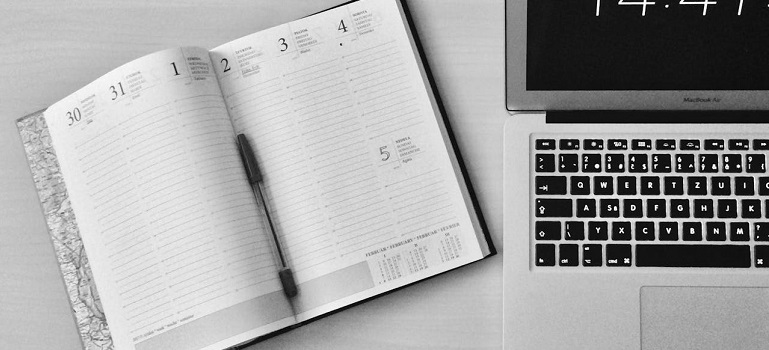 a notebook next to a laptop