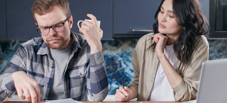 Two people calculating a cost of living