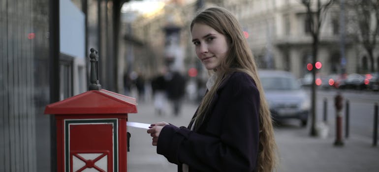A woman next to the mailbox