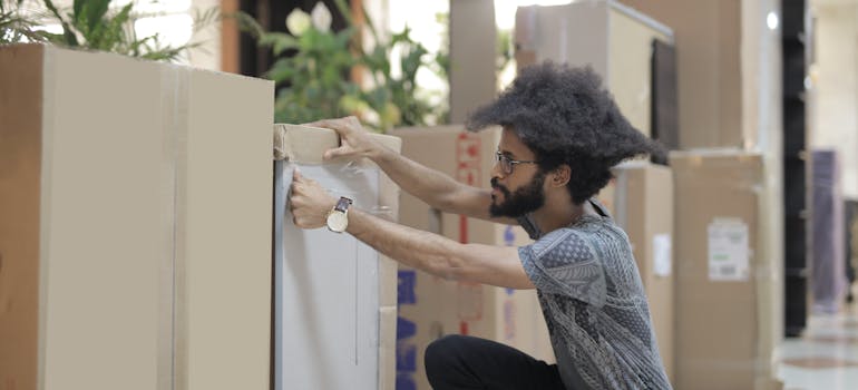 A person packing office items