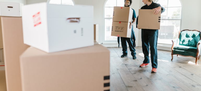 Two movers holding boxes
