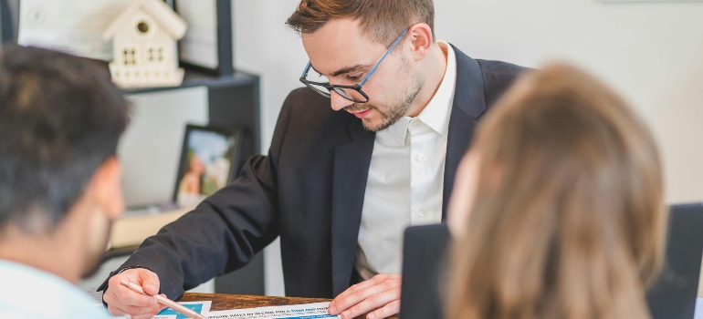 Real Estate Agent Discussing in Front of His Client