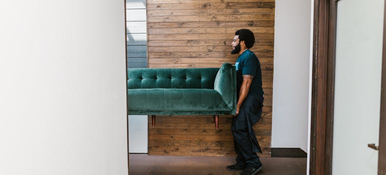 A mover carrying sofa