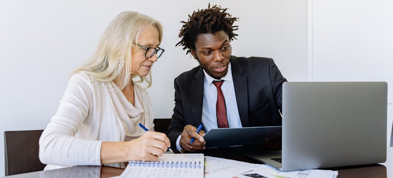 Two people using a laptop