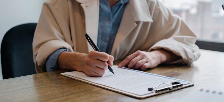 A person writing on the paper