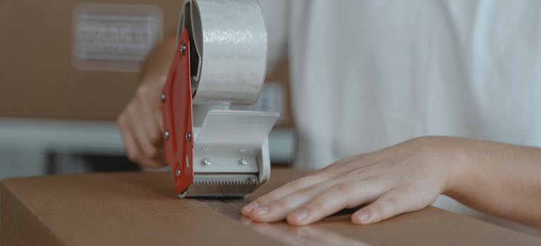 A person packing a moving box
