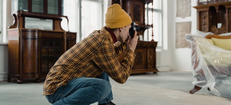A person taking picture of the antique furniture