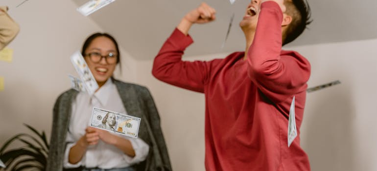 A happy person throwing dollar bills